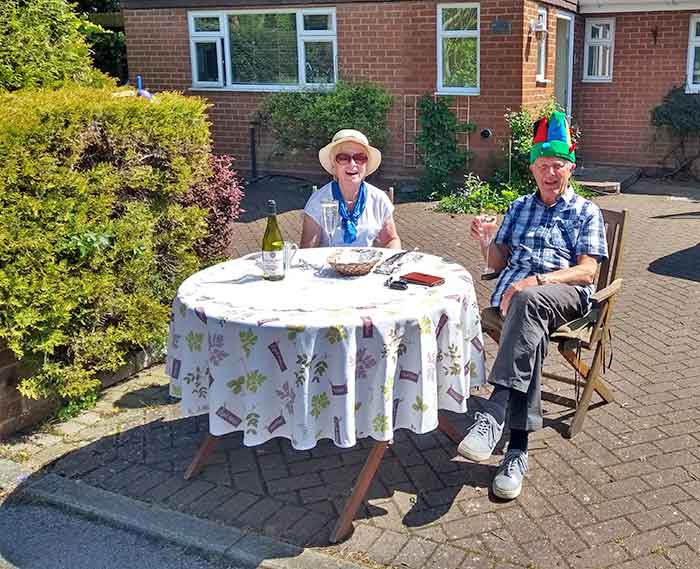 two people seated at table outdoors